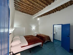 Postel nebo postele na pokoji v ubytování Hotel Riad Sahara Activity