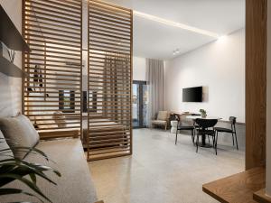 a living room with a table and a dining room at Nontas suites in Kato Daratso
