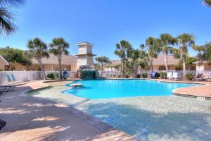 a swimming pool in a resort with palm trees at Palm Bay 307 in Padre Island