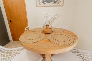 a wooden table with a vase on top of it at Cozy apartment with pool in Bacalar Center in Bacalar +32 photos