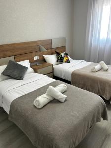 a hotel room with two beds with towels on them at Sunny Stay in Torre De La Horadada in Torre de la Horadada +42 photos