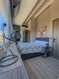 a bedroom with a bed and a table with a lamp at Ionian Pearl Apartments And Suites in Corfu Town