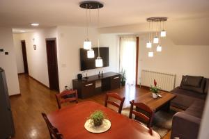 a living room with a table and a couch at Ego apartmanii in Ćuprija +13 photos