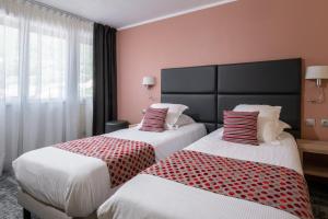 Postel nebo postele na pokoji v ubytování Hôtel Vauban Briançon Serre Chevalier