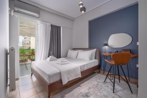 a bedroom with a bed and a table and a mirror at Luxurious Coastal Retreat in Central Glyfada in Athens