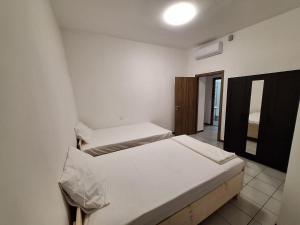 a bedroom with two beds in a room at Fiore Apartments in Fiorenzuola dʼArda