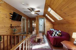 a living room with a couch and a ceiling fan at The Mitchell House in North Woodstock