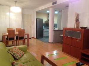 a living room and kitchen with a couch and a table at Calella Can Saula III in Calella