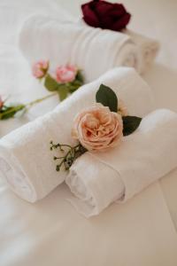 a rolled up towel with a flower on a bed at Elia House Nafplio in Nafplio