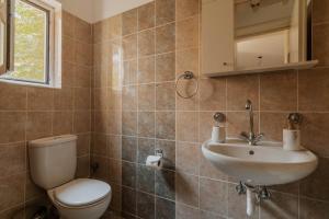 a bathroom with a toilet and a sink at Elia House Nafplio in Nafplio +37 photos