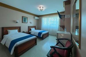 Postel nebo postele na pokoji v ubytování Apart Hotel Hamilton