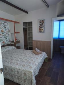 a bedroom with a bed and a window at A ponte in Pontevedra