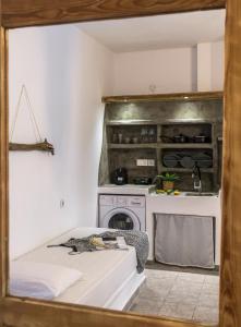 a bedroom with a stove and a bed in a room at Anerousses in Adamantas +51 photos
