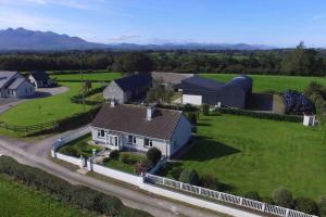 an aerial view of a house with a yard at Family farmhouse,Wild Atlantic way, Ring of Kerry in Knocknaman