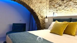Postel nebo postele na pokoji v ubytování Arco di Pietra B&B