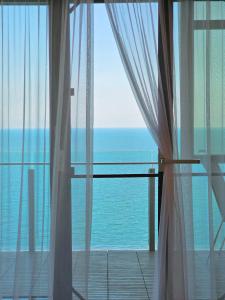 a view of the ocean from a room with a window at Starshine Spectrum Residence in Constanţa