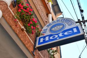 a sign for a hotel on the side of a building at Hotel el Marqués in Vallegrande