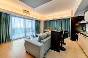 a living room with a couch and a table at Starshine Spectrum Residence in Constanţa