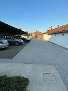 a parking lot with several cars parked in it at Vila Snezana in Gevgelija +8 photos