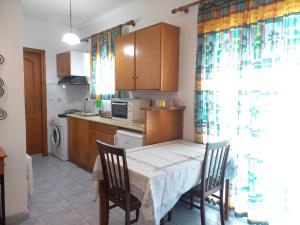 kuchnia ze stołem i dwoma krzesłami i stołem i kuchnia z w obiekcie Apartment Kasperakos w mieście Skiatos