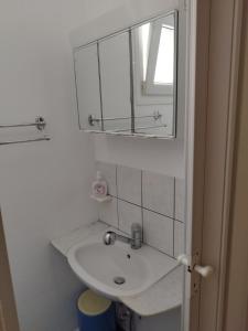 a white bathroom with a sink and a mirror at Iro's Cute House in Parikia +31 photos