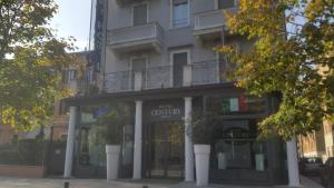 a store front of a building with a balcony at Century Hotel in Parma