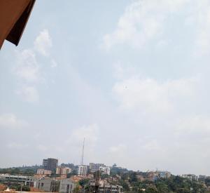 a view of a city with buildings in the background at Nandyowa Guesthouse in Kampala +1 photo
