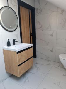 a bathroom with a sink and a mirror at Apartament zamkowa 1 in Żywiec