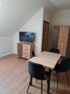 a conference room with a wooden table and chairs at Apartament zamkowa 1 in Żywiec