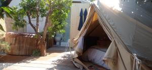 a bed in a tent in a garden at Le MER lodge in Vallauris