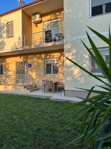 a house with a balcony and a table on a patio at Vila Snezana in Gevgelija