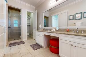 a bathroom with a shower and a sink and a mirror at Palmilla Beach Resort in Port Aransas +28 photos