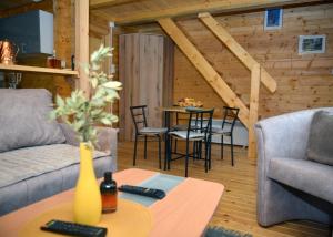 a living room with a couch and a table at Deda Misina Koliba in Ćuštica