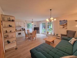 a living room with a couch and a table at Haus Erika in Prerow