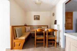 a living room with a couch and a table at Votsalo Spetses in Spetses +9 photos