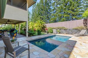 a swimming pool in the backyard of a house at Keiki Beach 6 at Kona Bay Estates in Kailua-Kona