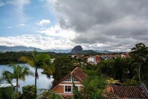a view of a city with a mountain in the background at Hotel Spa Bliss Guatape in Guatapé