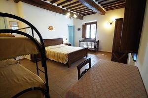 a bedroom with a bed and a room with a table at Agriturismo La Valle dei Fiori di Bellucci Rosanna in Torre deʼ Calzolari +89 photos