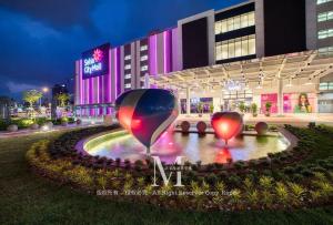 a hotel with two heart sculptures in front of it at Setia Alam Walking Distance Convention Centre Executive Suite 2Pax in Setia Alam