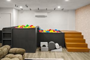 a childrens play room with a pile of colorful balls at Rock Climbing Wall Pool& Mini Golf Game Room Mural in Peoria