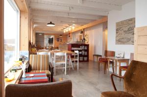 a restaurant with tables and chairs in a room at Tungulending Guesthouse in Tungulending