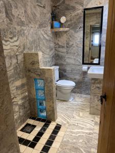 a stone bathroom with a toilet and a sink at Everley Cottage in Scarborough +8 photos