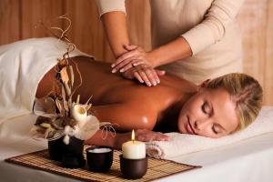 a woman getting a massage in a bed at 3 King Bedrooms - Beautiful New Port Richey in New Port Richey