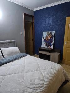 a bedroom with a white bed and a blue wall at Calm corner in Nairobi