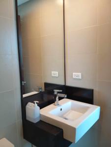 ein Badezimmer mit Waschbecken und großem Spiegel in der Unterkunft Consuelo Condominium Unit Rentals in Boracay