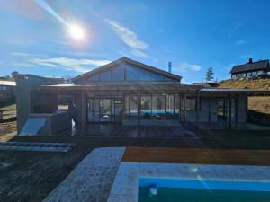 a rendering of a house with glass windows at Gran Cabaña Dos Yacanto in Villa Yacanto