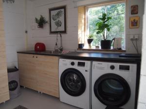 a kitchen with a washing machine and a sink at Söderstrand B&B Tammi Room in Suur Ahvenkoski