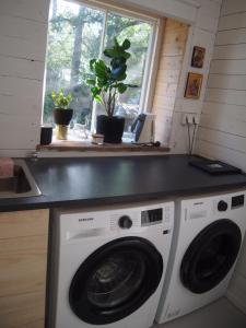 a kitchen with a washing machine and a counter at Söderstrand B&B Tammi Room in Suur Ahvenkoski +15 photos