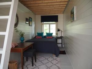a room with a bed and a table and a window at Söderstrand B&B Tammi Room in Suur Ahvenkoski