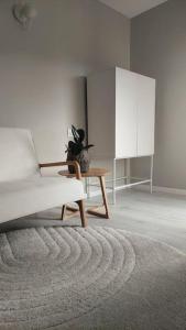 a living room with a chair and a table at Apartment Sarajevo Calling - Free parking in Sarajevo